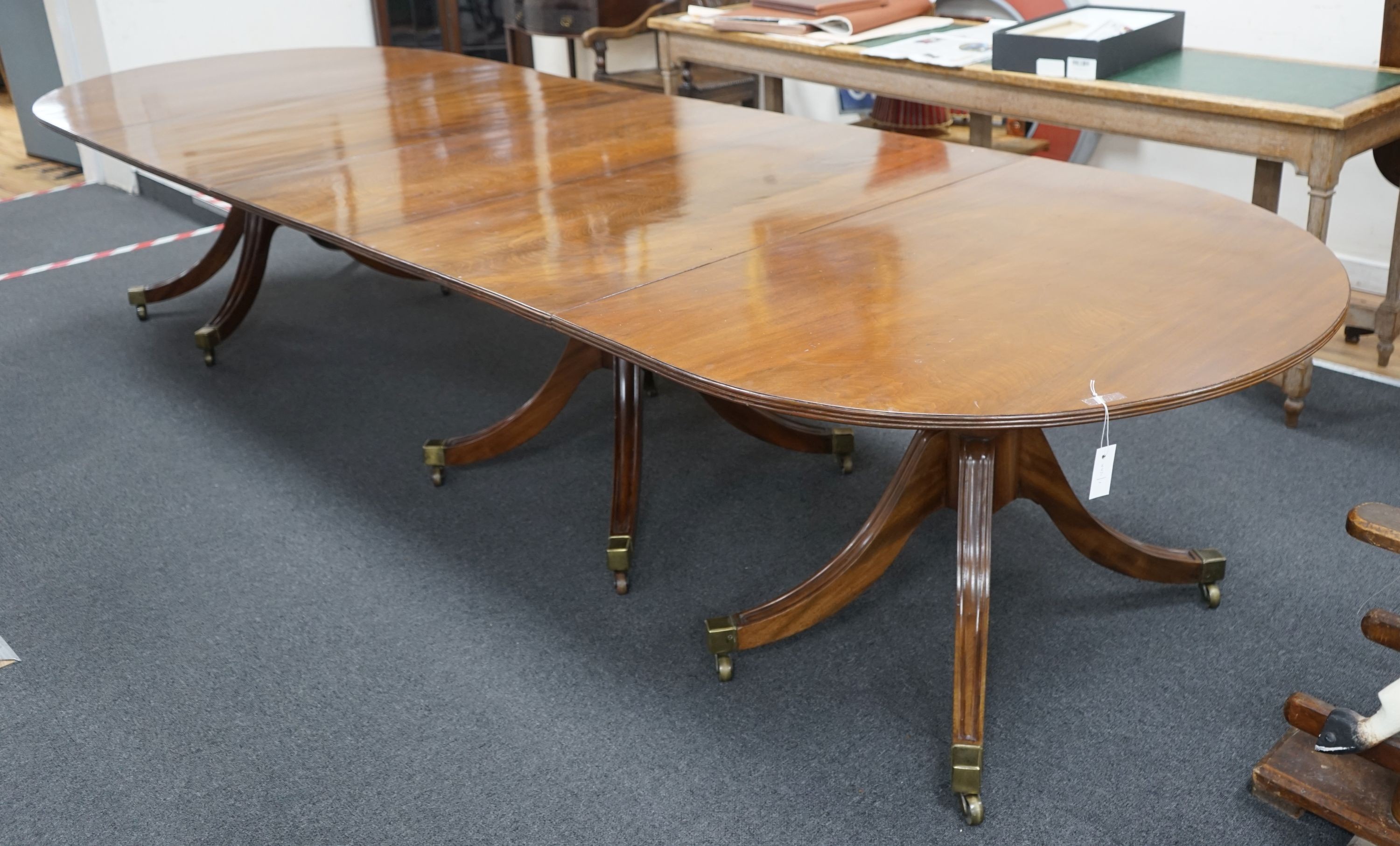 A George III and later mahogany three pillar D end extending dining table, one spare leaf, 376cm extended, width 128cm, height 72cm